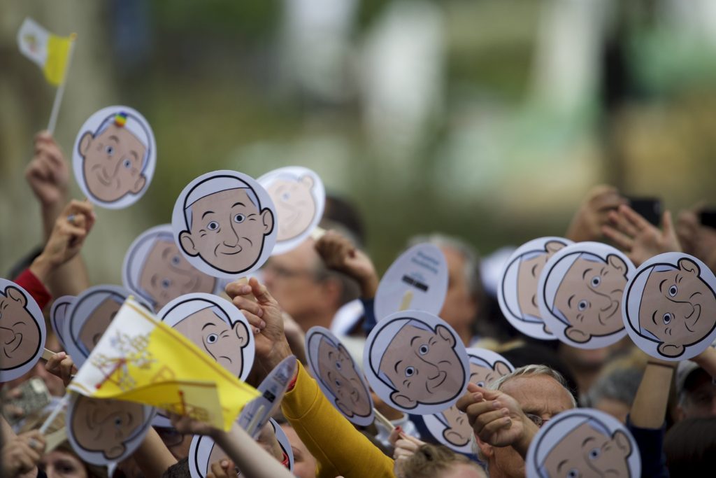 Pilgrims wave cardboard cutouts of Pope Francis as they gather outside the Cathedral Basilica of SS. Peter and Paul to see the pope in Philadelphia Sept. 26. (CNS photo/Mark Makela, Reuters)