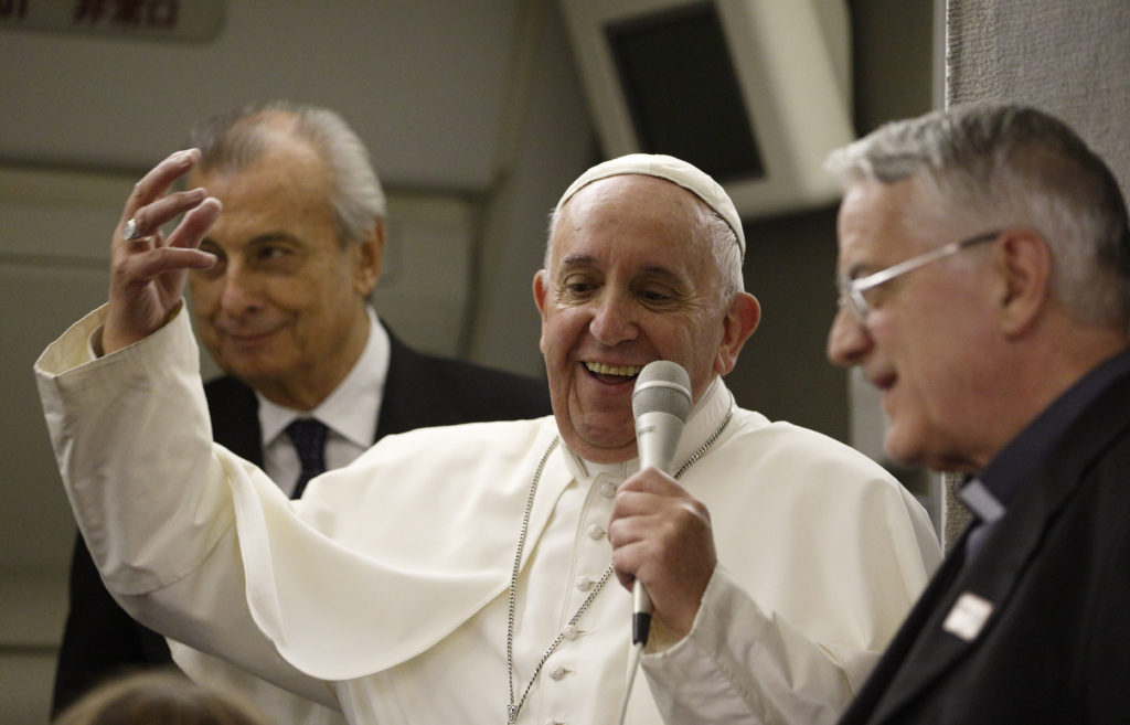 Pope Francis speaks with journalists aboard his flight from Philadelphia to Rome Sept. 27. (CNS photo/Paul Haring)