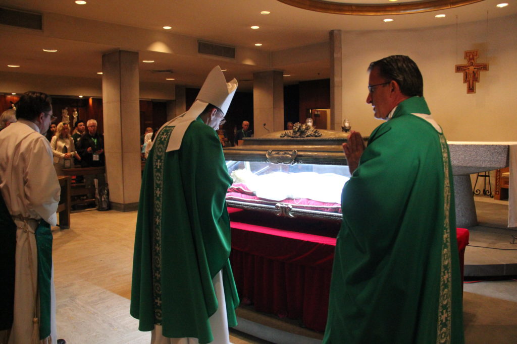 Phoenix Bishop Thomas J. Olmsted venerates the relics of St. Maria Goretti during a Mass he celebrated at St. John the Evangelist Paris in Philadelphia for Arizona pilgrims to the World Meeting of Families. (Justin Bell/CATHOLIC SUN)