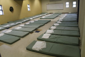 Sleeping mats line a meeting room where dozens of women without shelter can temporarily rest for the night inside St. Vincent de Paul's dining room facilities on the Human Services Campus. (Ambria Hammel/CATHOLIC SUN)