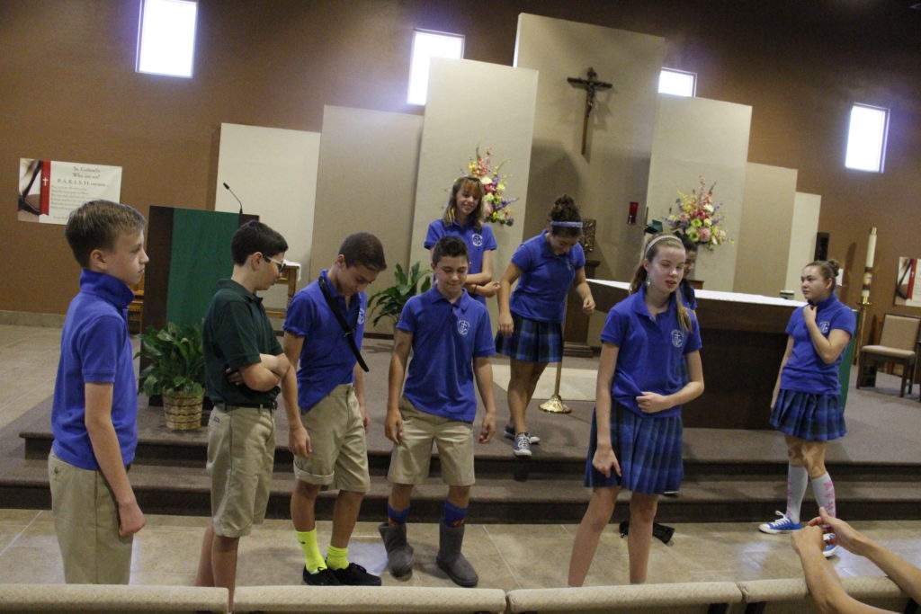 Students from Annunciation Catholic School's first eighth grade class perform a skit for other students about how not to act in Mass. (Ambria Hammel/CATHOLIC SUN)