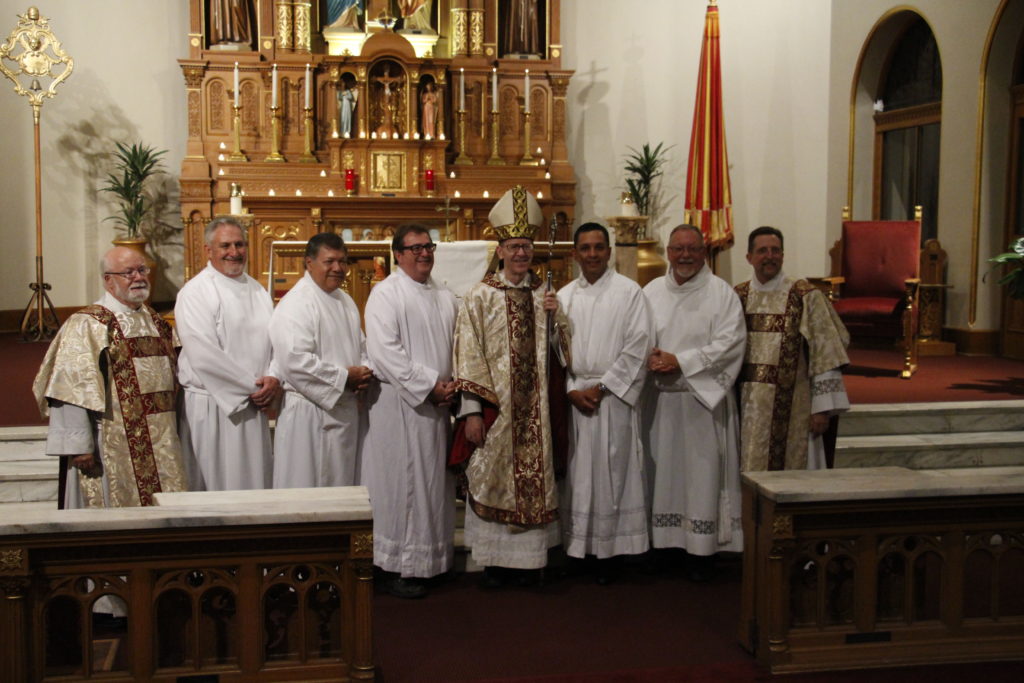 Deacon candidates Tony Smith, Marvin Silva, Gary Scott, William Chavira and Christopher Giannola pose with Deacons Jim Trant and Doug Bogart and with Bishop Thomas J. Olmsted following their institution to the ministry of acolyte Aug. 28 at St. Mary's Basilica. The men are discerning the diaconate. (Ambria Hammel/CATHOLIC SUN)