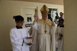 Bishop Thomas J. Olmsted blesses the second story hallways at Queen of Peace School Sept. 19. (Ambria Hammel/CATHOLIC SUN)