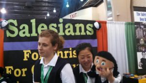 A group of Salesians use puppets to engage children in one of the exhibit booths at the World Meeting of Families. (Joyce Coronel/CATHOLIC SUN)