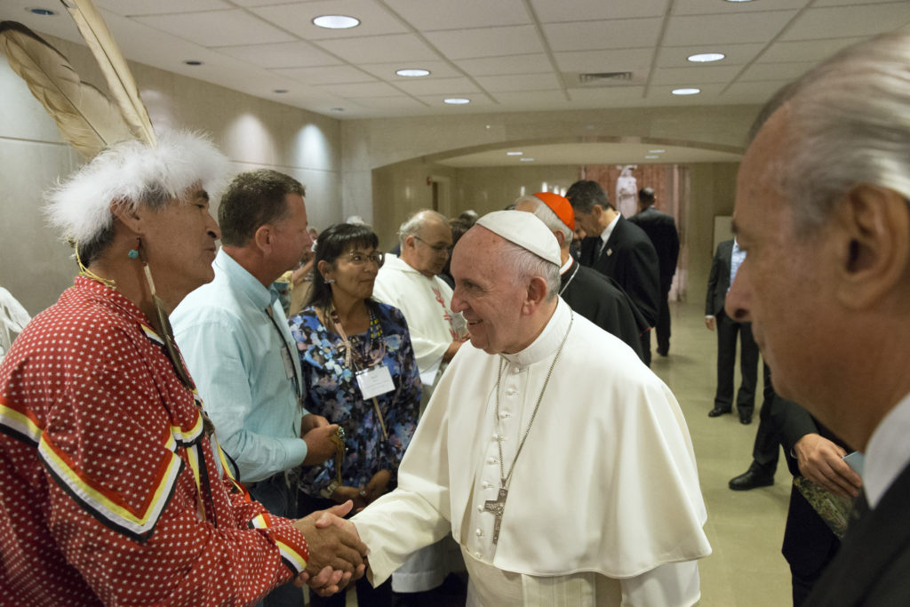 Pope Francis greets guests including California Indians following Mass and the canonization of St. Junípero Serra at the Basilica of the National Shrine of the Immaculate Conception in Washington Sept. 23. (CNS photo/Paul Haring)