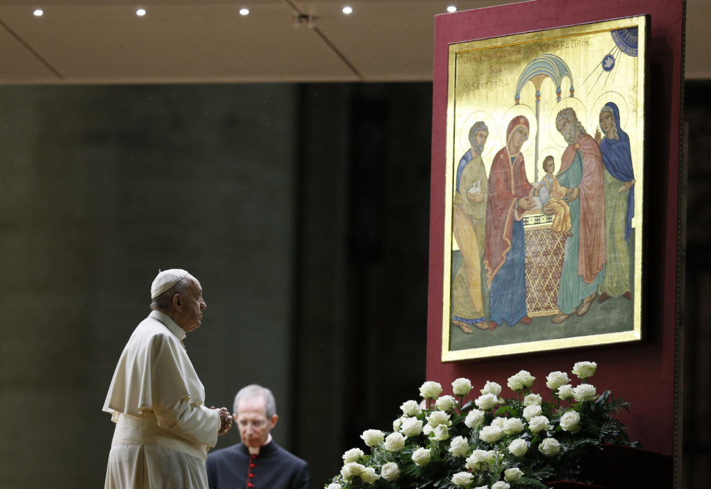 Pope Francis prays in front of an image of the Holy Family during a prayer vigil for the Synod of Bishops on the family in St. Peter's Basilica at the Vatican Oct. 3. (CNS/Paul Haring)