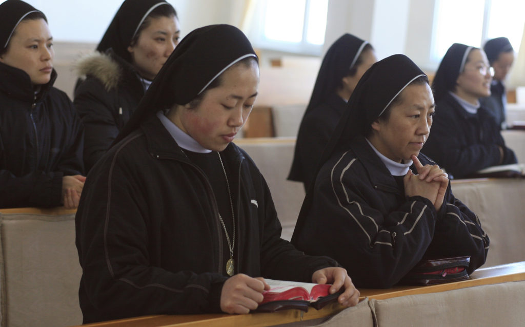 Members of the Sisters of the Sacred Heart pray in their motherhouse chapel in Fushun, China, in this 2007 file photo. Catholic female religious orders have expanded rapidly in China over the past decade, but are now facing restrictions and a fall in vocations, according to nuns from various parts of the country. (CNS photo/Nancy Wiechec) 