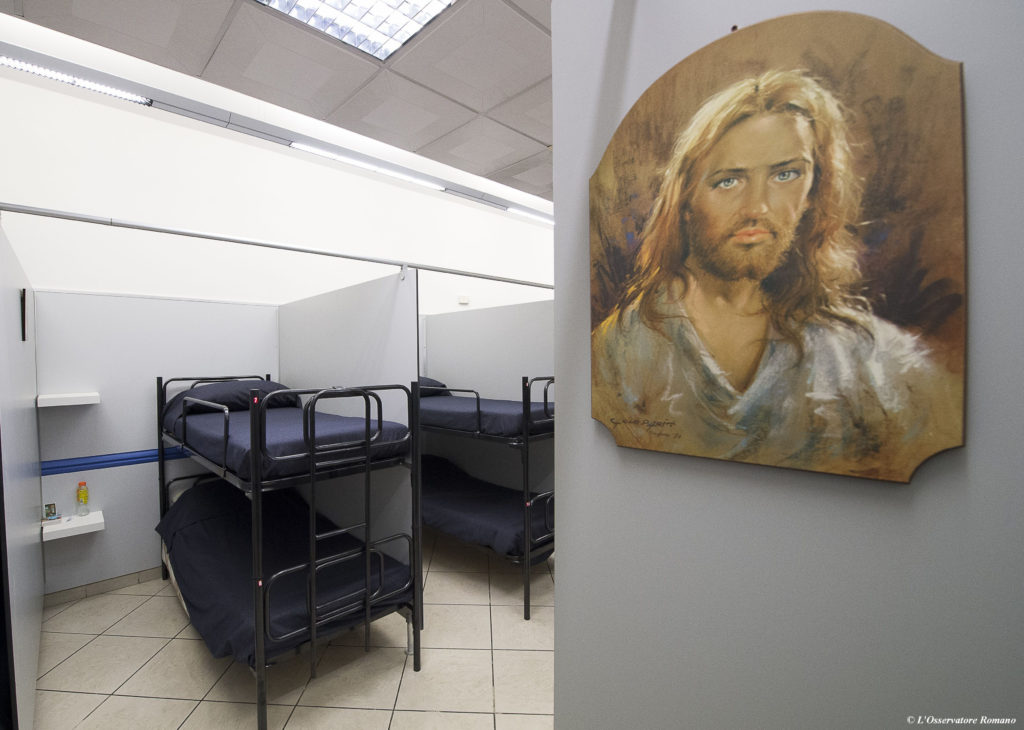 An image of Christ is seen near beds Oct. 8 inside the Gift of Mercy, a shelter for homeless men, just a few hundred yards away from St. Peter's Square. Housed in a Jesuit-owned building, the shelter was created by and is run with funds from the papal almoner, who has taken a variety of initiatives to assist the homeless people in the area surrounding the Vatican. (CNS photo/L'Osservatore Romano, handout) 