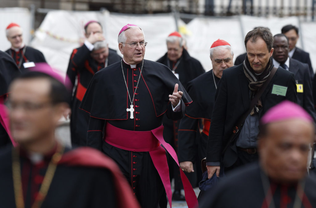 Archbishop Joseph E. Kurtz of Louisville, Ky., president, U.S. Conference of Catholic Bishops, center, gestures as he arrives for a session of the Synod of Bishops on the family at the Vatican Oct. 14. (CNS photo/Paul Haring) 