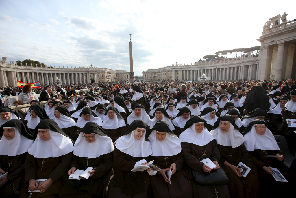 Nuns wait for Pope Francis to lead the Oct. 18 Mass for the canonization of four new saints in St. Peter's Square at the Vatican. Pope Francis canonized Spanish Sister Maria of the Immaculate Conception, a member of the Congregation of the Sisters of the Company of the Cross; Italian Father Vincenzo Grossi, founder of the Institute of the Daughters of the Oratory; and Louis and Marie Zelie Guerin Martin, the parents of St. Therese of Lisieux. (CNS photo/Alessandro Bianchi, Reuters)