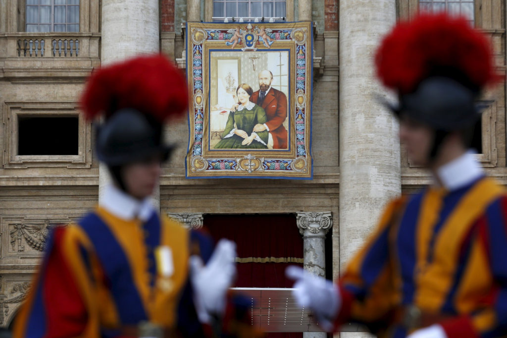 A tapestry showing Louis and Zelie Martin, parents of St. Therese of Lisieux, hangs from a balcony as Pope Francis leads the Oct. 18 Mass for their canonization in St. Peter's Square at the Vatican. Pope Francis also canonized Spanish Sister Maria of the Immaculate Conception, a member of the Congregation of the Sisters of the Company of the Cross, and Italian Father Vincenzo Grossi, founder of the Institute of the Daughters of the Oratory. (CNS photo/Alessandro Bianchi, Reuters)