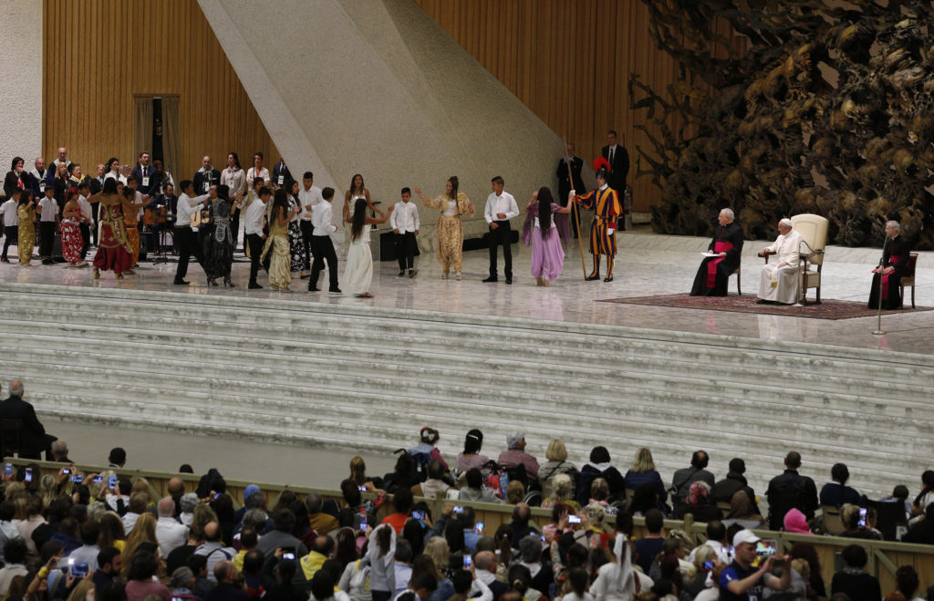 Pope Francis watches as dancers perform during an audience with Roma, Sinti and Irish Travelers and other itinerant communities in Paul VI hall at the Vatican Oct. 26. The pope called for an end to centuries of prejudice against Gypsy communities. (CNS photo/Paul Haring) 