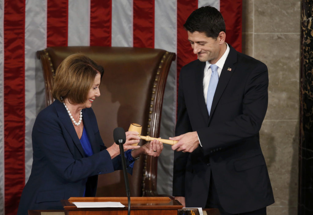 Former U.S. House Speaker and current Minority Leader Nancy Pelosi, D-Calif., hands incoming House Speaker Paul Ryan, R-Wis., the gavel after his election on Capitol Hill in Washington Oct. 29. In his acceptance speech Ryan pledged to get the chamber working for the American people again. (CNS photo/Gary Cameron, Reuters)