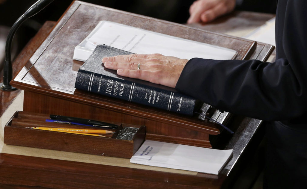 Newly elected Speaker of the U.S. House of Representatives Paul Ryan, R-Wis., places his hand on a Bible as he is sworn in on Capitol Hill in Washington Oct. 29. He succeeds outgoing speaker, Rep. John Boehner, R-Ohio. (CNS photo/Jonathan Ernst, Reuters)