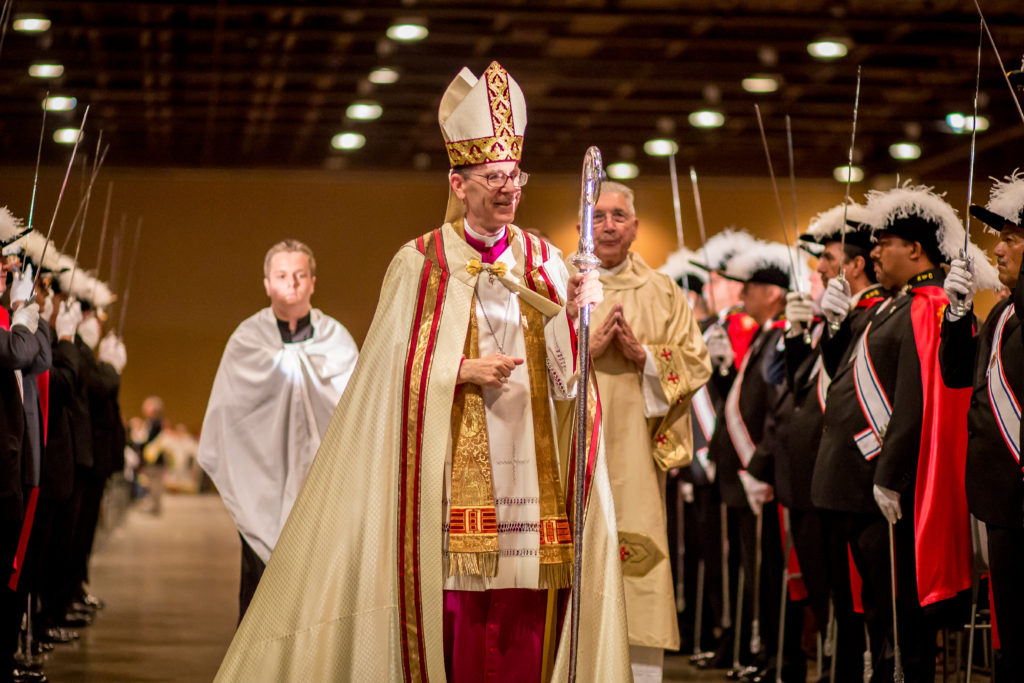 Fourth Degree members of the Knights of Columbus salute Bishop Thomas J. Olmsted during the opening procession at Rosary Celebration. The Knights have been organizing the annual event for more than 10 years. (Billy Hardiman/CATHOLIC SUN)