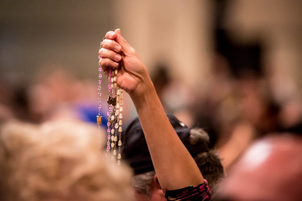 A woman holds up her rosaries to be blessed at the 40th annual Rosary Celebration held Sunday, Oct. 25 at the Phoenix Convention Center. (Billy Hardiman/CATHOLIC SUN)