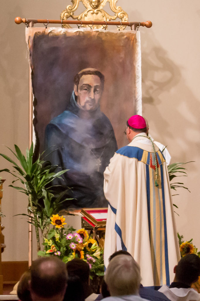 Bishop Nevares incenses the ­portrait of St. Serra that was painted by local artist and St. Mary’s Basilica parishioner Renee Bau Sept. 23. (Billy Hardiman/CATHOLIC SUN)