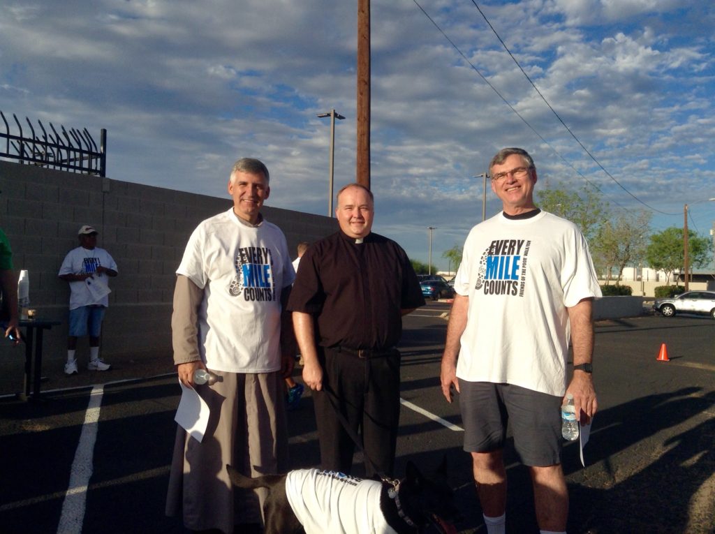 Pictured from left to right are: Fr. Dale Craig, SOLT, pastor of Most Holy Trinity Parish, Fr. Steven Kunkel, pastor of St. Thomas the Apostle Parish, and Fr. Michael Weldon, OFM, rector of St Mary's Basilica. Fr. Kunkel participated in the walk with his dog, a rescue dog named Hope. (Lindsay Wantland/CATHOLIC SUN)