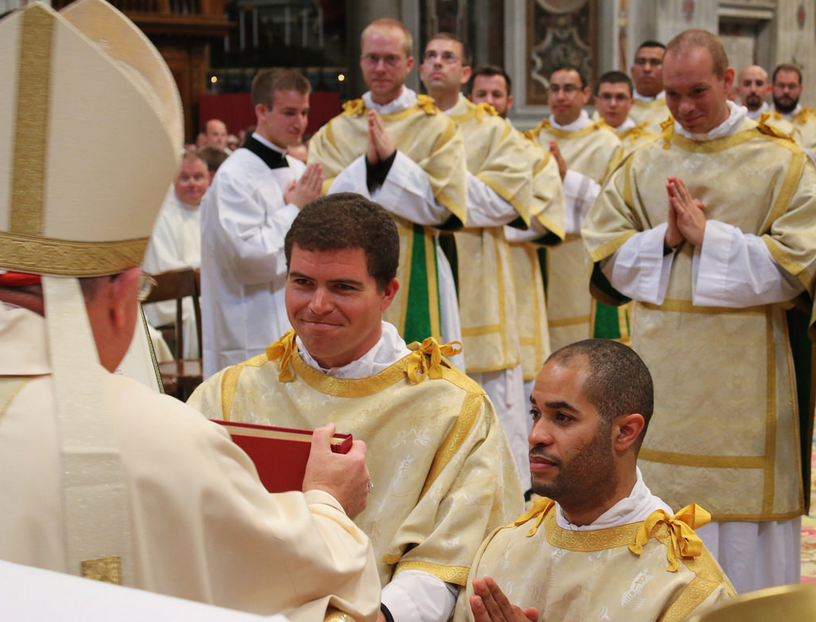 Dcn. Dan Connealy receives the Book of the Gospels during his ordination in Rome Oct. 1. (Leo Song/PNAC PHOTO SERVICE)