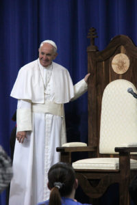 Pope Francis stands next to the chair that was constructed by inmates at the prison. (Justin Bell/CATHOLIC SUN)