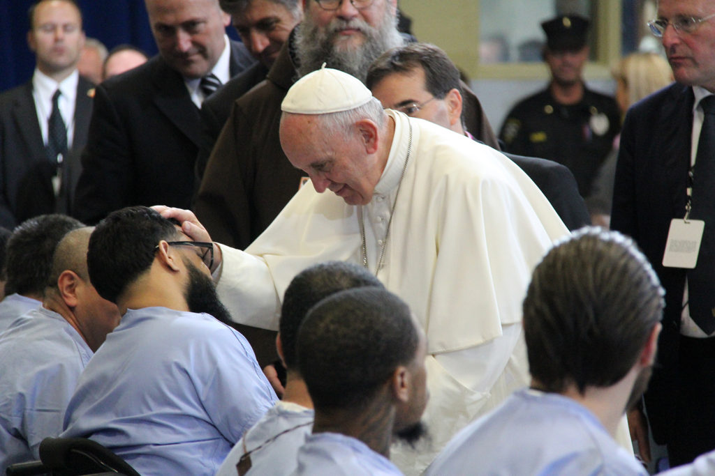 Pope Francis blesses an inmate at teh Curran-Fromhold Prison in Philadelphia Sept. 27 during his Apostolic Visit to the U.S. The Holy Father greeted each inmate personally after delivering remarks aimed at encouraging them to get their lives back on track during their imprisonment. (Justin Bell/CATHOLIC SUN)