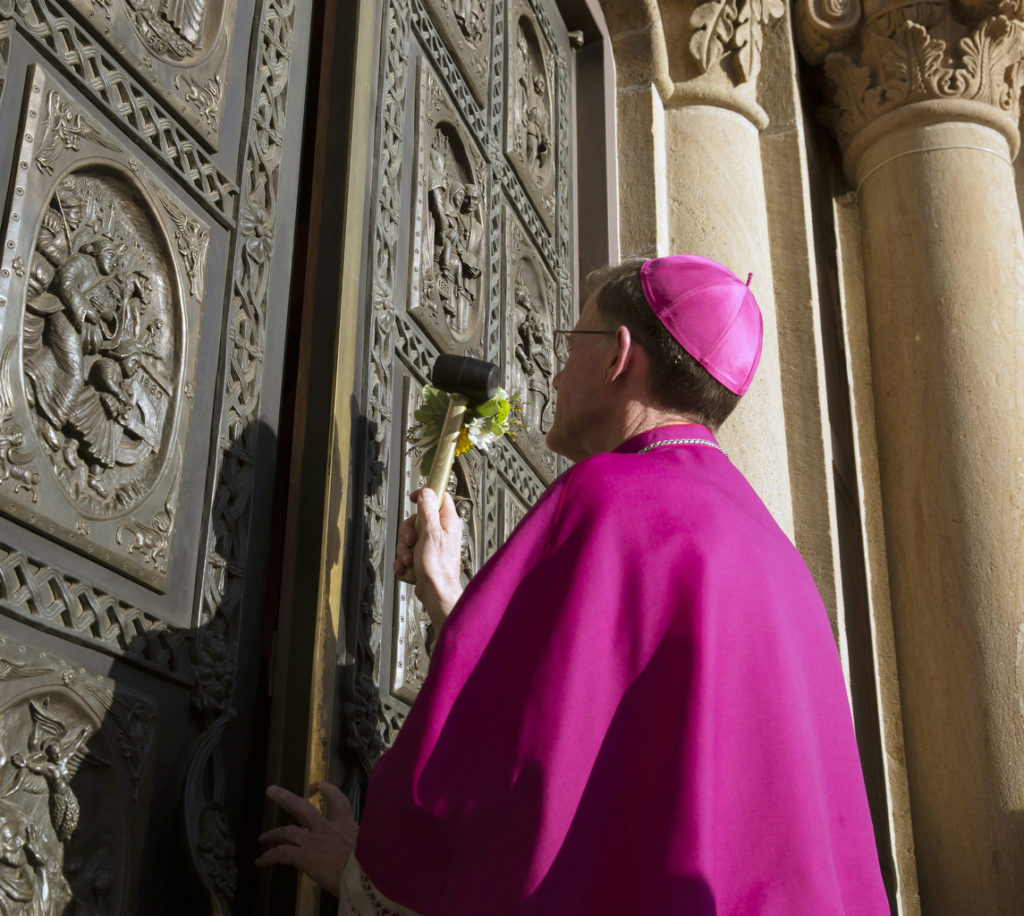 Archbishop John C. Wester knocks on the doors of the Cathedral Basilica of St. Francis of Assisi in Santa Fe, N.M., June 3. A celebration of vespers marked the eve of his installation as the 12th Catholic archbishop of Santa Fe. (CNS photo/Nancy Wiechec)