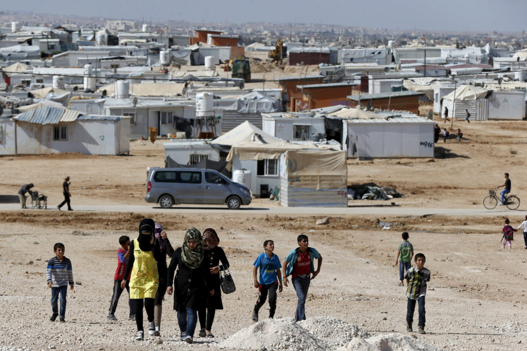 Syrian refugees walk at Zaatari refugee camp in the Jordanian city of Mafraq, near the border with Syria, Nov. 1. The U.N. refugee agency reports that currently about 100 Syrians return home nearly every day from Jordan. (CNS photo/Muhammad Hamed, Reuters)
