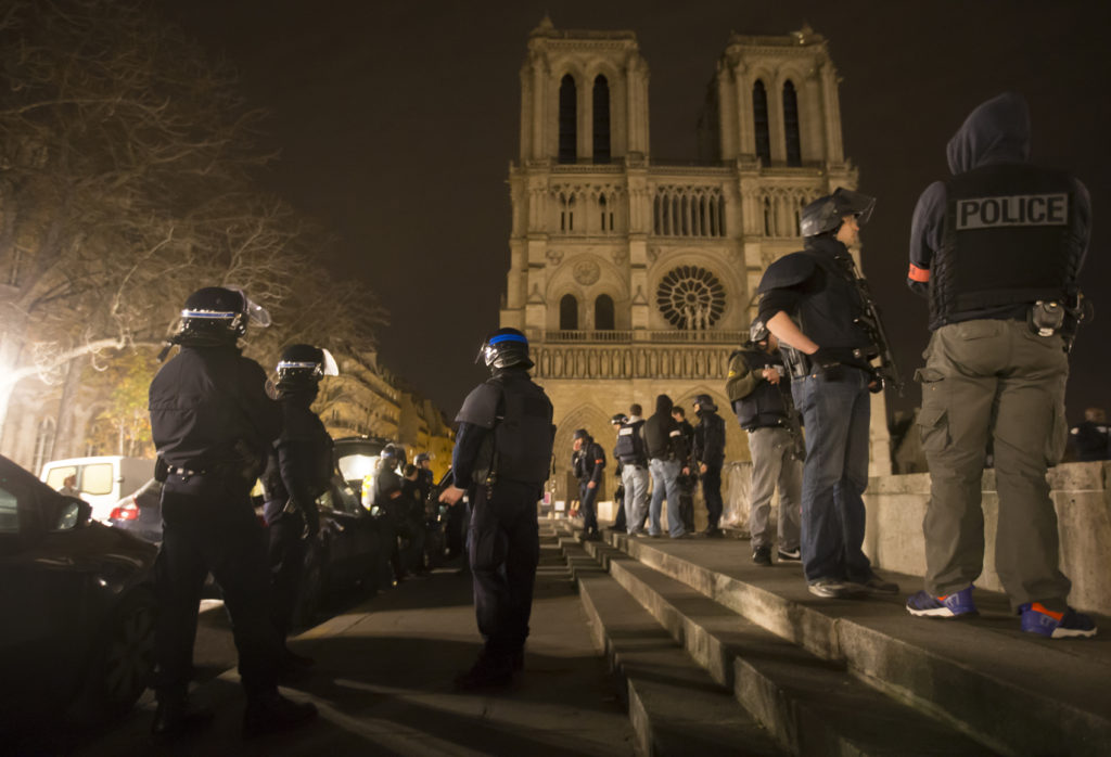 Armed police officers go on foot patrol around Notre Dame Cathedral in Paris Nov. 14. Dozens of people were killed in a series of attacks in Paris Nov. 13. (CNS photo/Ian Langsdon, EPA)