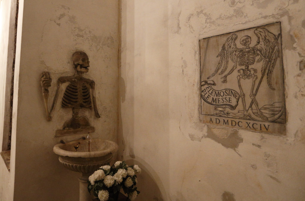 Human bones decorate a wall in the crypt of the Church of St. Mary of the Oration and Death, the headquarters of a confraternity with a legacy of burying the dead, in Rome Nov. 18. (CNS photo/Paul Haring) 