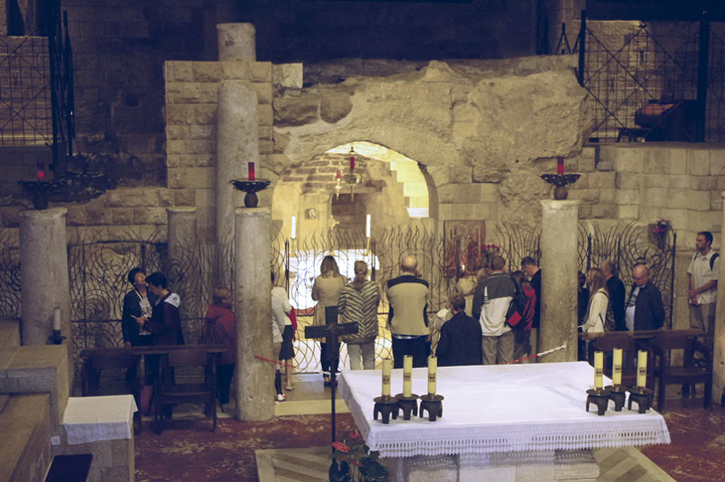 Pilgrims kneel before the Grotto of the Annunciation in Nazareth Nov. 5. The site has been a pilgrimage destination for centuries. The basilica was built in 1969 over the remains of Byzantine and crusader churches. (Joyce Coronel/CATHOLIC SUN)