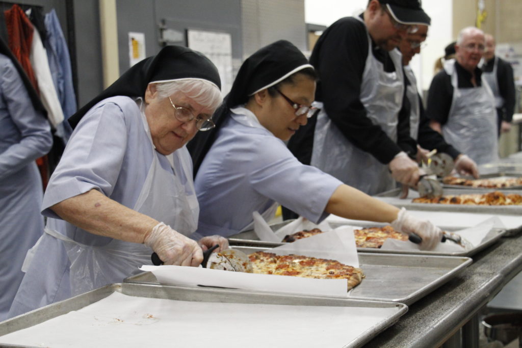 Sisters, religious and diocesan priests made pizza night possible from start to finish at St. Vincent de Paul's Family Dining Room Oct. 30. Some also made cordial visits to the tables where families ate and to the Dream Center where children stayed busy with a variety of activities. (Ambria Hammel/CATHOLIC SUN)