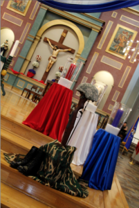 Patriotic imagery sprinkled throughout St. Thomas Aquinas Parish for the Nov. 8 Red, White and Blue Mass. That included a trio of candles lit in honor or those who died in service, men and women in uniform and colors of the flag. All helped serve as reminders why Catholics should honor veterans and military families. (Ambria Hammel/CATHOLIC SUN)
