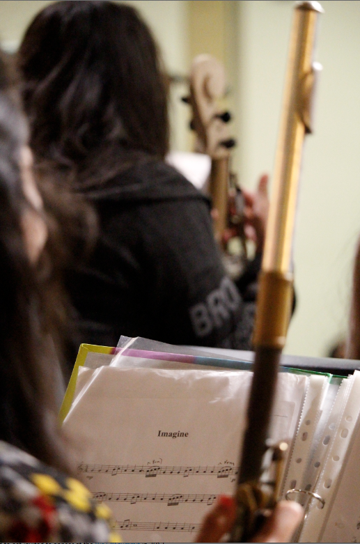 Musician rest their instruments during a teaching concert at St. Daniel the Prophet Parish in Scottsdale Nov. 6. Membership in the Recycled Orchestra of Cateura inspired its musicians to dream. (Ambria Hammel/CATHOLIC SUN)