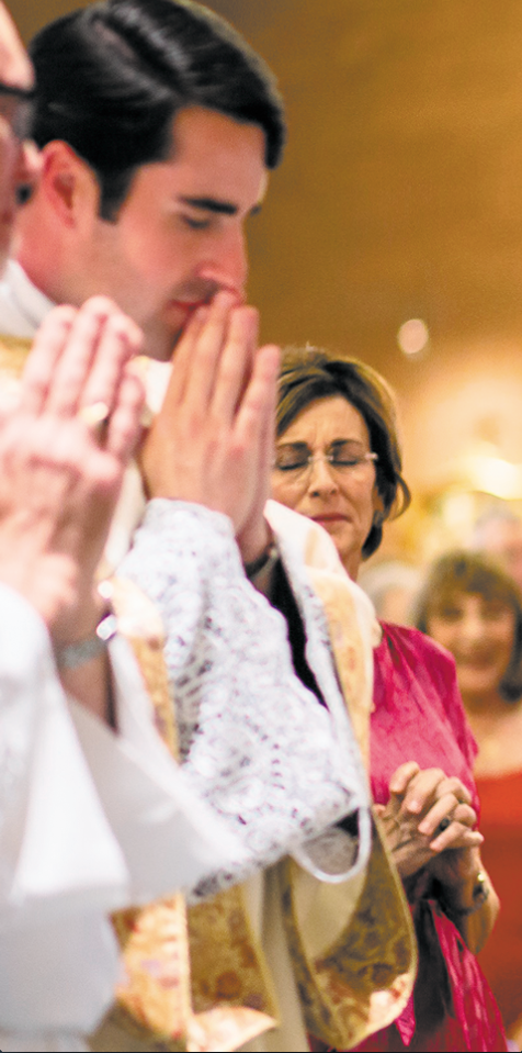 Rita Lee prays silently near her son, transitional Dcn. Ryan Lee, shortly after his ordination May 31. Lee organized a prayer group for moms whose children are discerning religious vocations. (Catholic Sun file photo)