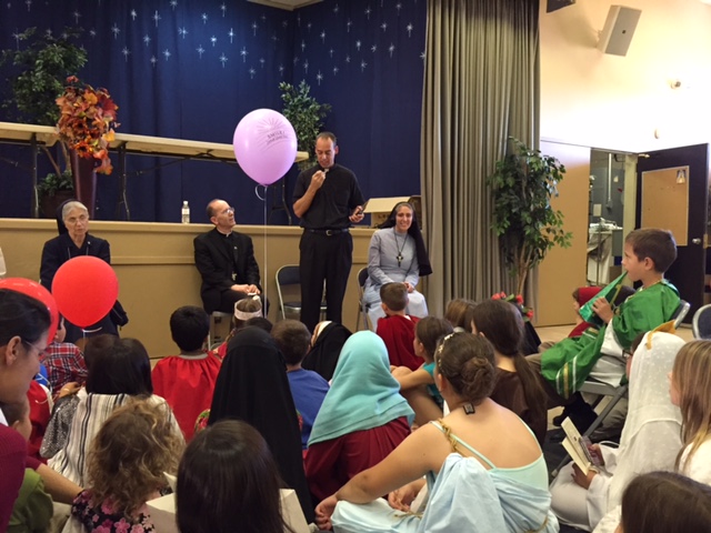 Fr. Paul Sullivan, diocesan director of vocations, addresses the children and parents who attended the vocations celebration Nov. 1 at Blessed Sacrament Parish in Scottsdale. 