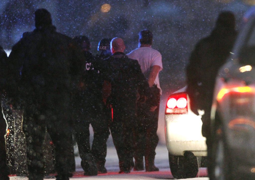 A suspect is taken into custody Nov. 27 outside a Planned Parenthood clinic in Colorado Springs, Colo. Police say Robert Lewis Dear killed three people during the shooting rampage and hours-long standoff at the clinic and was later taken into custody. (CNS photo/Rick Wilking, Reuters)