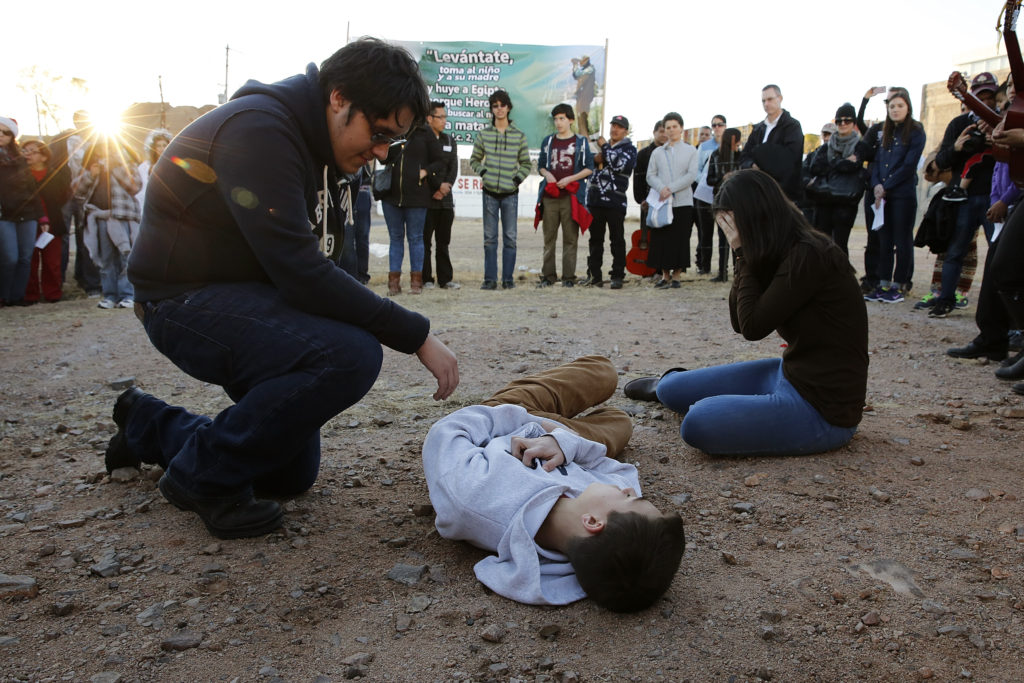 Kino Teens from Arizona act out the tragedies that can befall migrants as the students take part in a binational "posada" in Nogales, Mexico, Dec. 20. The "posada," recalling Mary and Joseph's search for shelter before the birth of Christ, reflected on the struggles of migrants and migrant families. (CNS photo/Nancy Wiechec) 