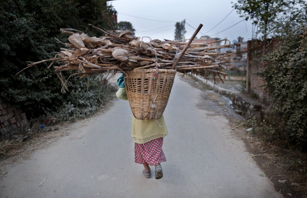 A Nepalese woman carries firewood on her back as she returns home in Lalitpur Dec. 21. The church in Nepal is preparing for a bleak Christmas as the Himalayan nation passes through one of the worst crisis in its history following the April 25 earthquake and an Indian blockade. (CNS photo/Narendra Shrestha, EPA) 