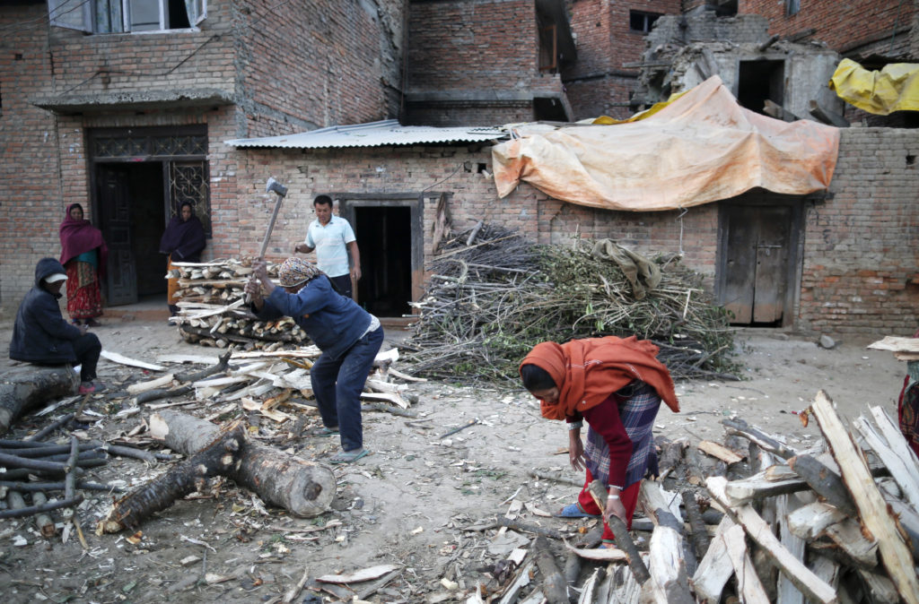 Nepalese who lost their home in the April 25 earthquake chop firewood in Lalitpur Dec. 21. The church in Nepal is preparing for a bleak Christmas as the Himalayan nation passes through one of the worst crisis in its history following the earthquake and an Indian blockade. (CNS photo/Narendra Shrestha, EPA) 