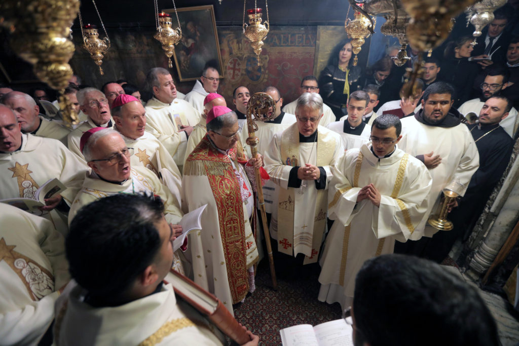 Latin Patriarch Fouad Twal of Jerusalem, center left, leads a Christmas procession in the Church of the Nativity in Bethlehem, West Bank. (CNS photo/Fadi Arouri, pool via EPA) 