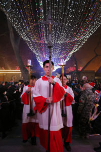 An altar server carries a crucifix as he leads a procession during Christmas Eve Mass at a Catholic church in Beijing. After claiming 2014 to be the worst year for religious persecution in China since the Cultural Revolution, observers in and outside the country say 2015 saw the situation deteriorate further. (CNS photo/Wu Hong, EPA) 