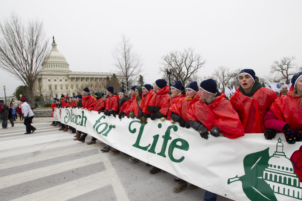Young people walk with a banner past the U.S. Capitol in 2012 during the annual March for Life in Washington. (CNS photo/Bob Roller) 