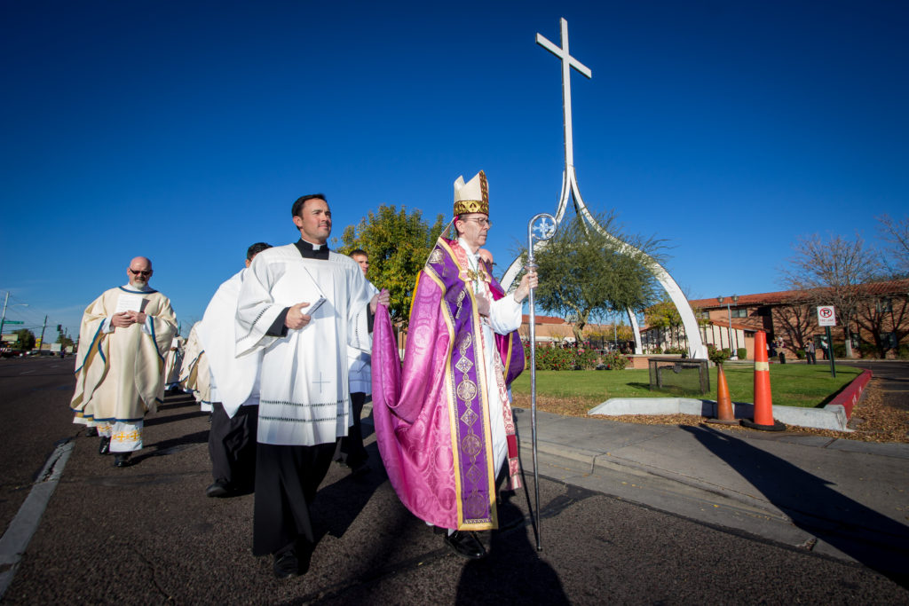 Bishop Thomas J. Olmsted leads a procession of approximately 1,200 faithful Catholics along 27th Avenue toward the front of the cathedral Dec. 13. (Billy Hardiman/CATHOLIC SUN)