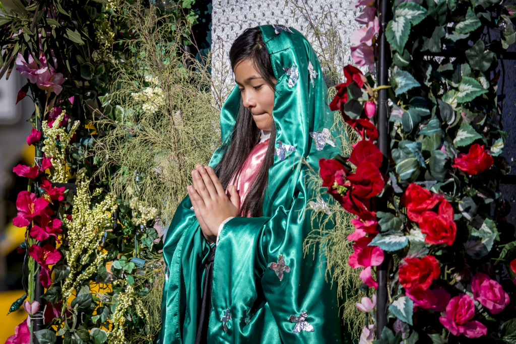 Karen Lopez poses on her float during the Honor Your Mother celebration parade and mass in Downtown Phoenix Dec. 5 (Billy Hardiman/CATHOLIC SUN)