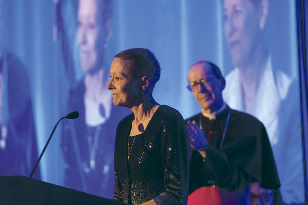 Guardian of Hope honoree Margaret Gillespie addresses Catholic Schools supporters at the Night of Hope as Bishop Thomas J. Olmsted looks on. (John Caballero/CATHOLIC SUN)
