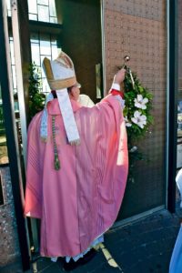 Bishop Nevares blesses the open doors to the Chapel of the Holy Cross, designating them as Holy Doors of Mercy. (Photo courtesy of Bob Simari)