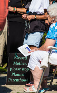 Pro-life supporters recite the rosary with Bishop David L. Ricken of Green Bay, Wis., during a prayer service in late August 2015 outside of a Planned Parenthood facility in Grand Chute, Wis. The abortion facility announced in early October that it was suspending abortion services for six months. (CNS photo/Sam Lucero, The Compass) 