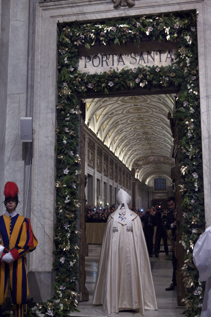 Pope Francis pauses after opening the Holy Door before Mass at the Basilica of St. Mary Major in Rome Jan. 1, 2016. The Holy Doors of Rome's four major basilicas are now open. (CNS photo/Maria Grazia Picciarella, pool)