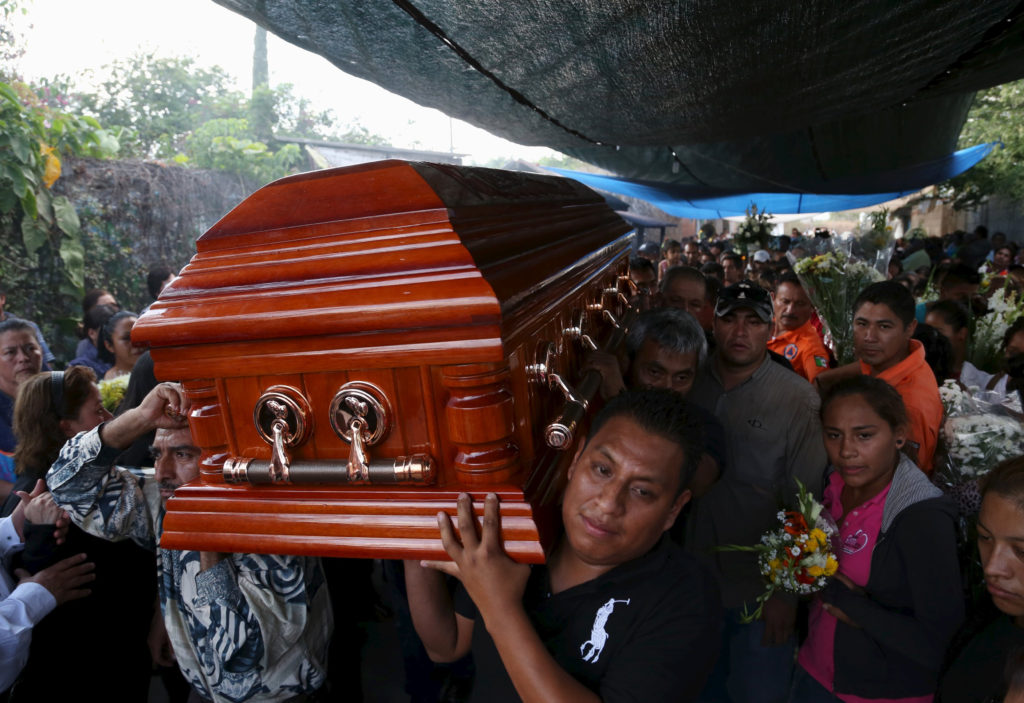 The coffin of Gisela Mota, former mayor of Temixco, Mexico, is carried out of her home Jan. 3. Mota was killed Jan. 2, one day after taking oath of office.  (CNS photo/Margarito Perez, Reuters) 
