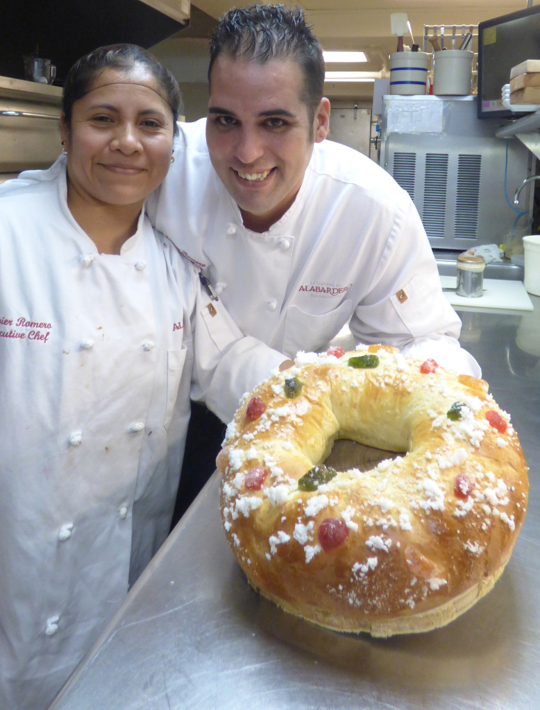 Margarita Castillo, chief pastry chef at Washington's Taberna del Alabardero, and Javier Romero, executive chef, display a finished roscon de reyes, a cake traditionally savored during the Epiphany in Mexico and Spain. The cake is similar to the king cake, but is starting to appear more often in January at the tables of immigrants living in the U.S. (CNS photo/Rhina Guidos) 